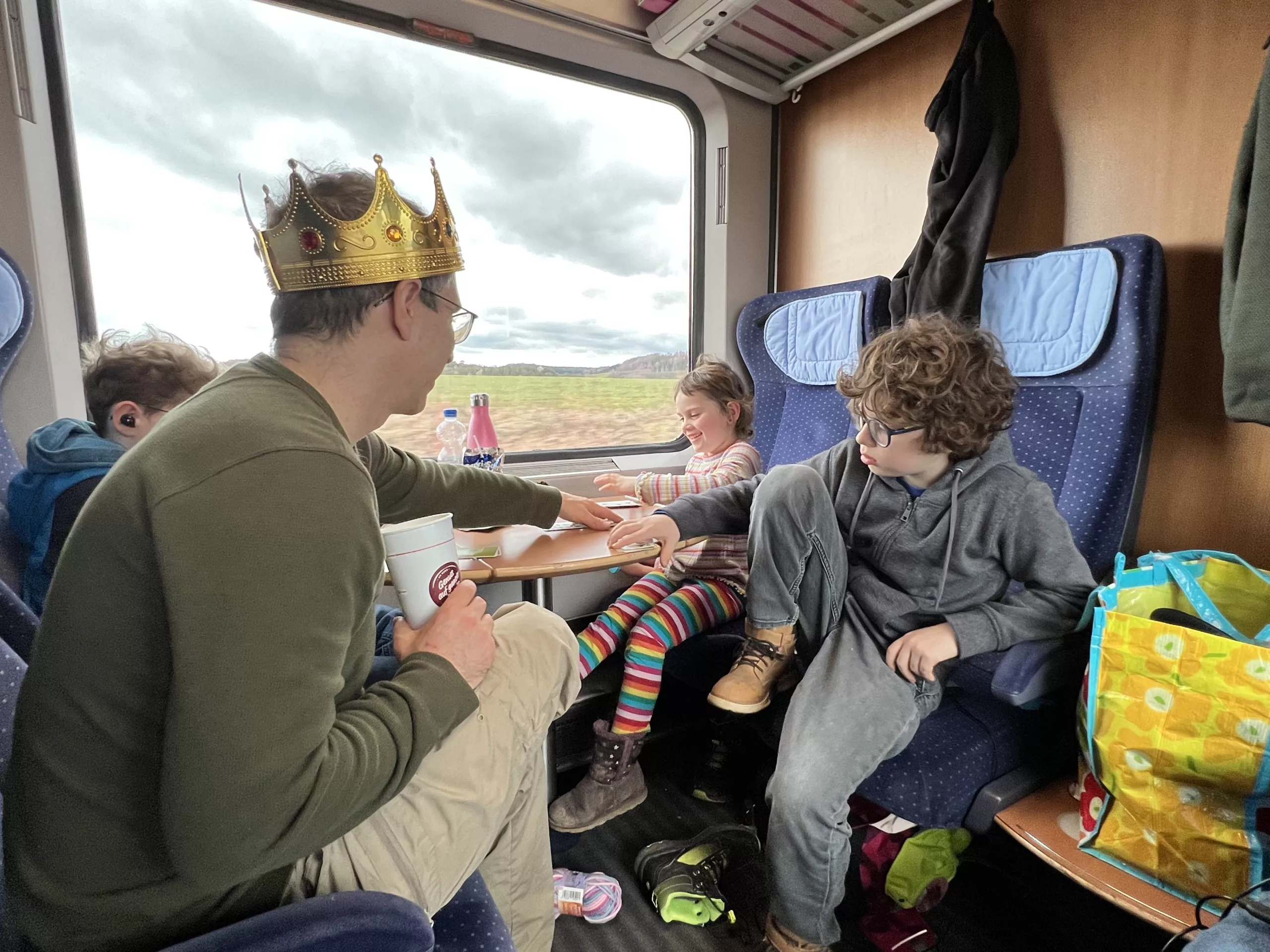 Our first-ever long distance ICE train trip in Germany. Here were are playing cards in our family cabin, or Abteil.